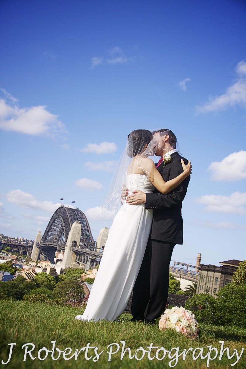 Couple kissing under veil observatory hill sydney - wedding photography sydney